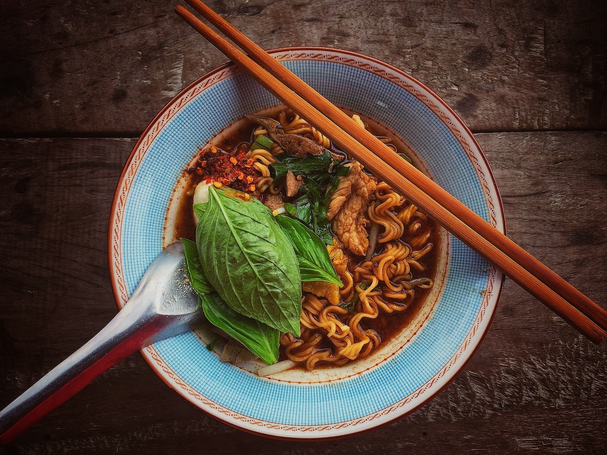 easy ramen in a bowl with herbs and chopsticks 