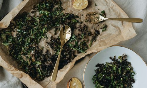 baking tray with kale crisps on it