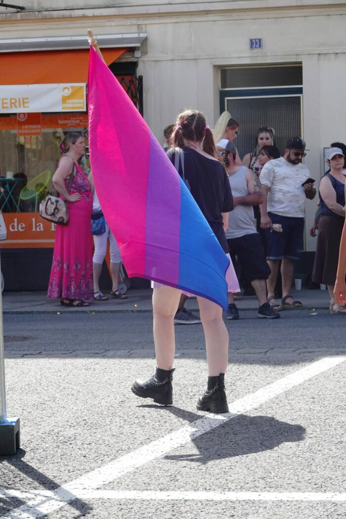 Person holding bisexual pride flag