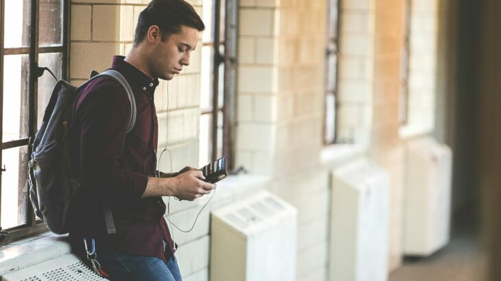 Man on the phone to student finance in the hallway