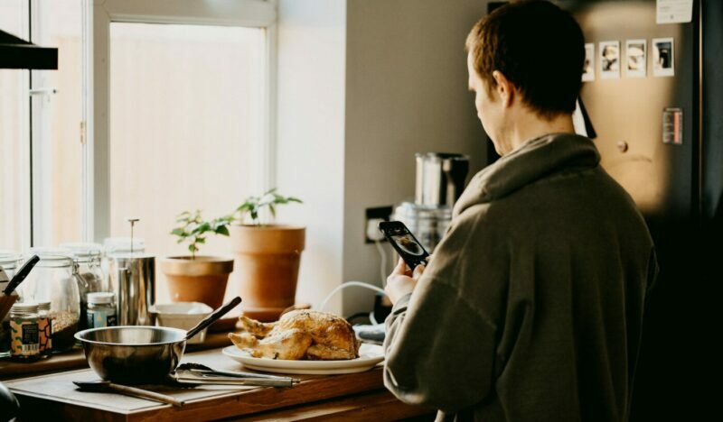 Person taking a photo of their Christmas dinner they've cooked