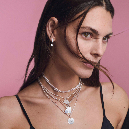 lady on pink background with necklaces