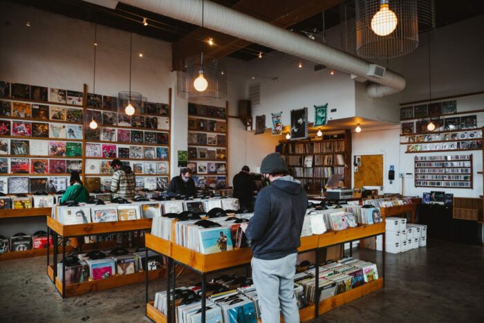 People browsing in vintage record store. Charity shops and vintage shops Liverpool