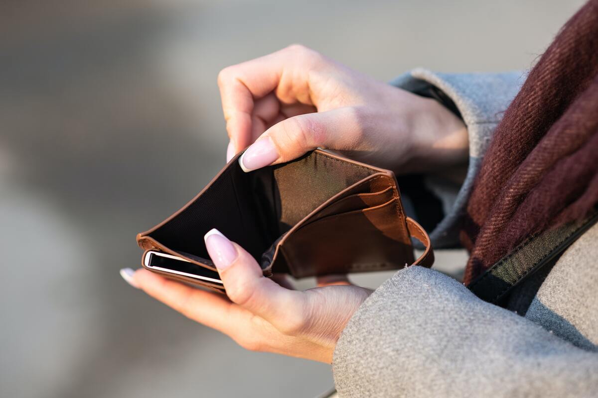 Woman holding empty wallet